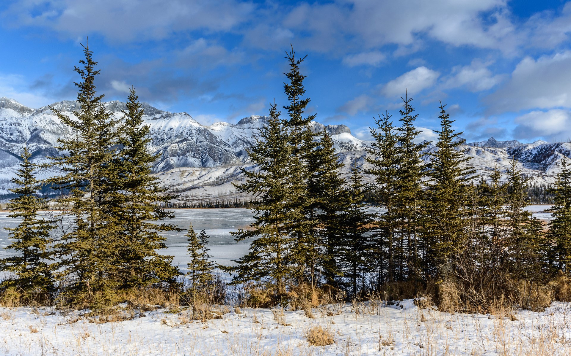 Snowy Mountains and Frozen Lake with Evergreen Trees HD Wallpaper