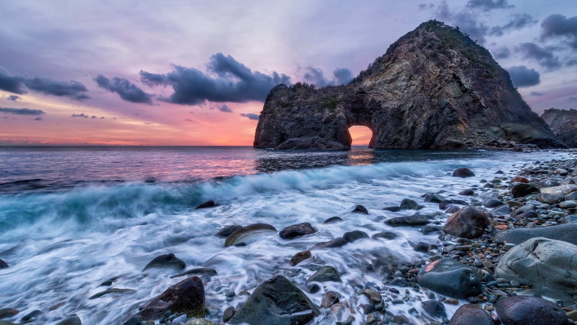 Ocean beach with rock arch at sunset HD Wallpaper