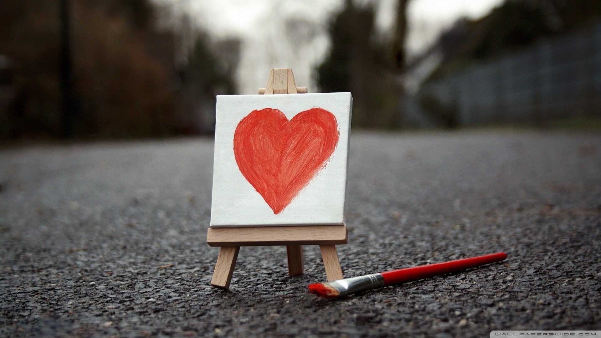 Painting of a red heart on a canvas with a paintbrush HD Wallpaper