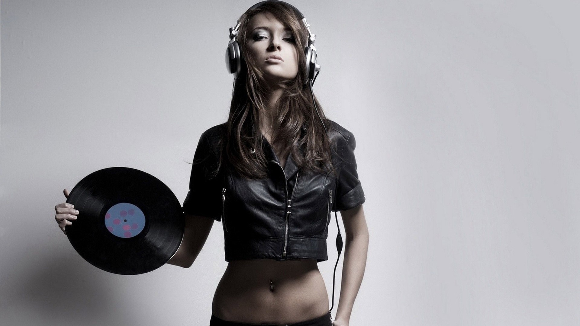 Woman with headphones holding a vinyl record HD Wallpaper