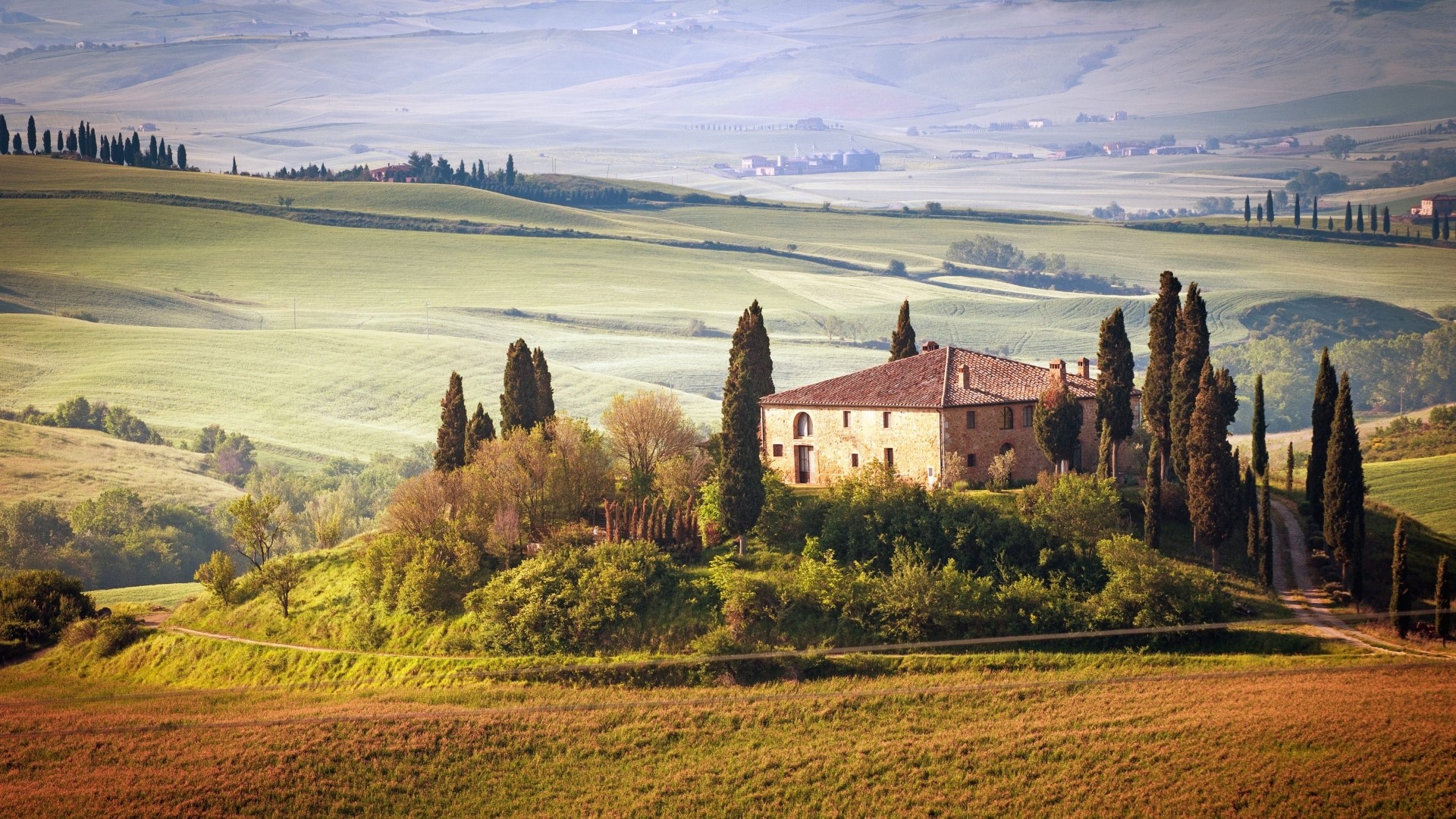 Tuscan Villa surrounded by rolling hills and cypress trees HD Wallpaper