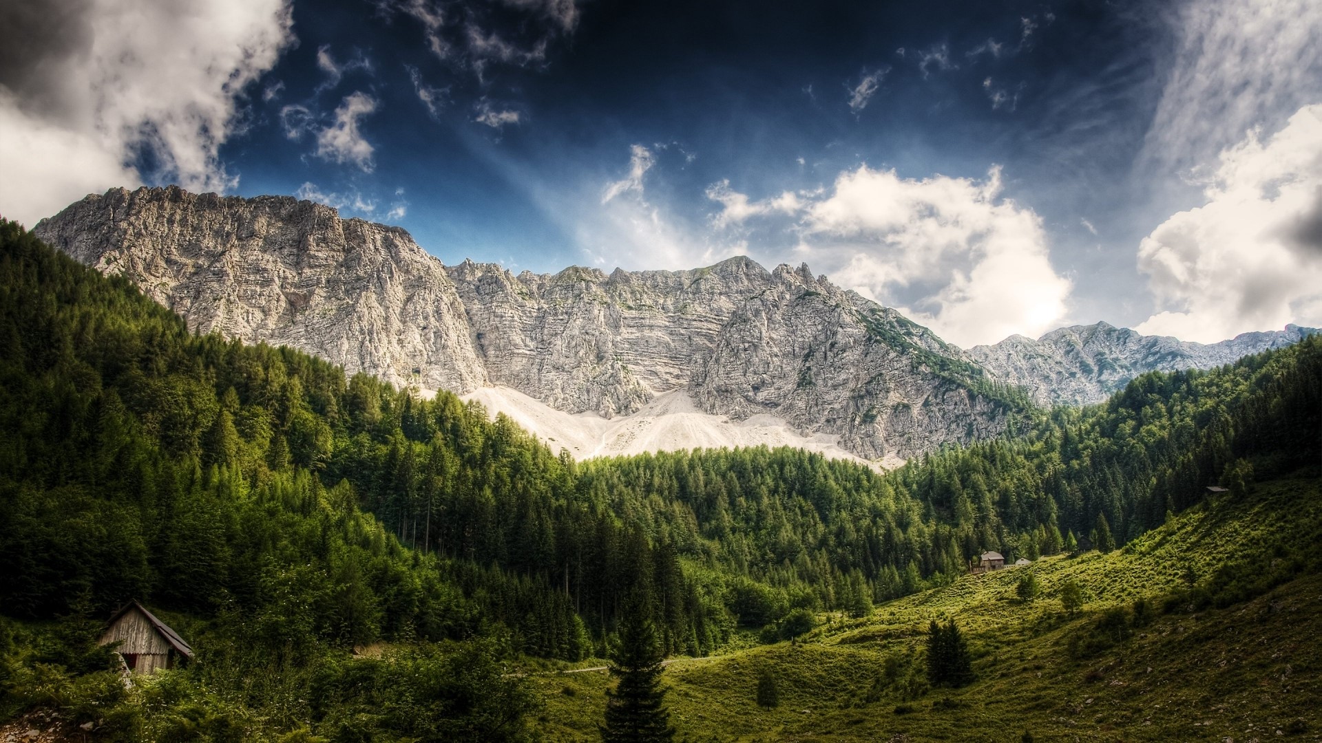 Mountain range with forest and cabins HD Wallpaper