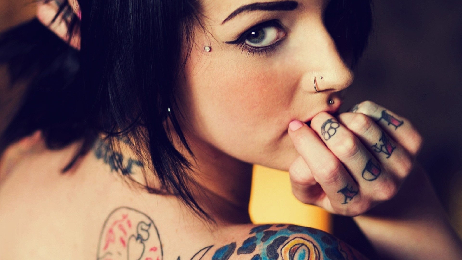 Tattooed woman with piercings and makeup HD Wallpaper