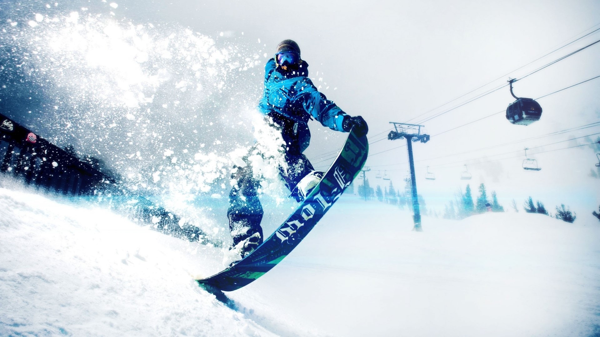 Snowboarder jumping with ski lift in background HD Wallpaper