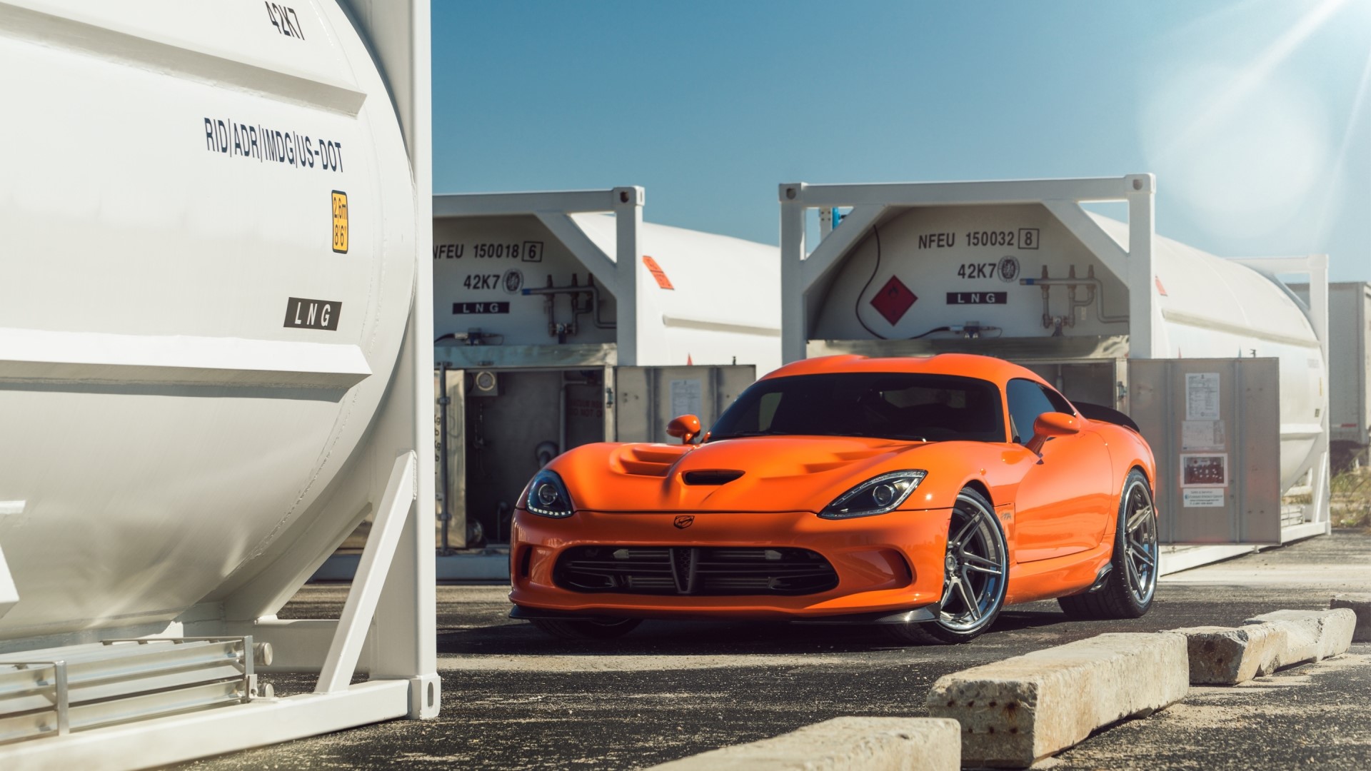 Orange Dodge Viper parked near LNG containers HD Wallpaper
