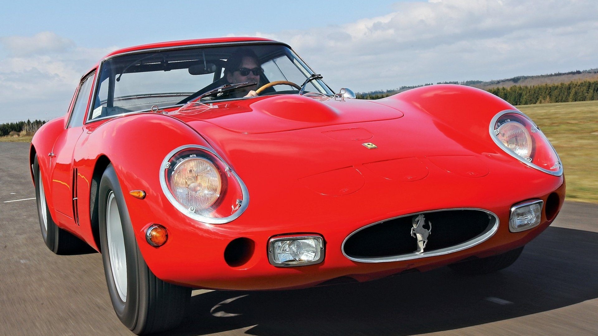 Red Ferrari 250 GTO driving on a road HD Wallpaper