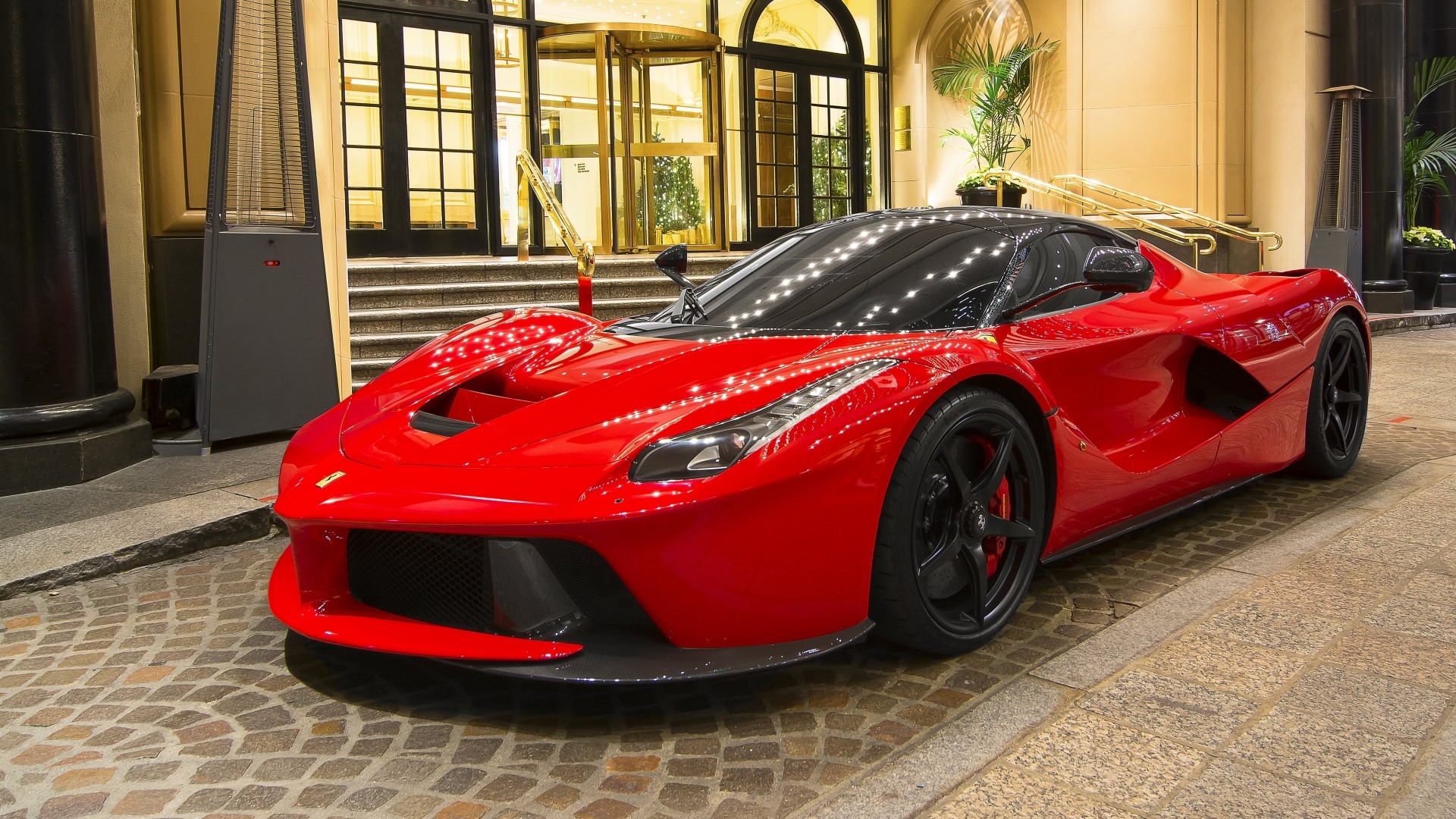 Red Ferrari LaFerrari parked outside a building HD Wallpaper
