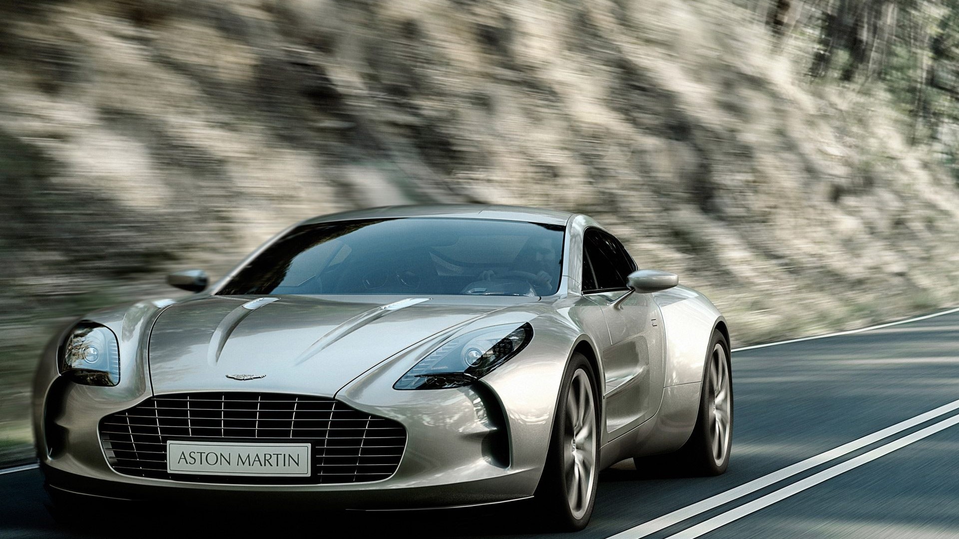 Aston Martin One-77 driving on a road HD Wallpaper