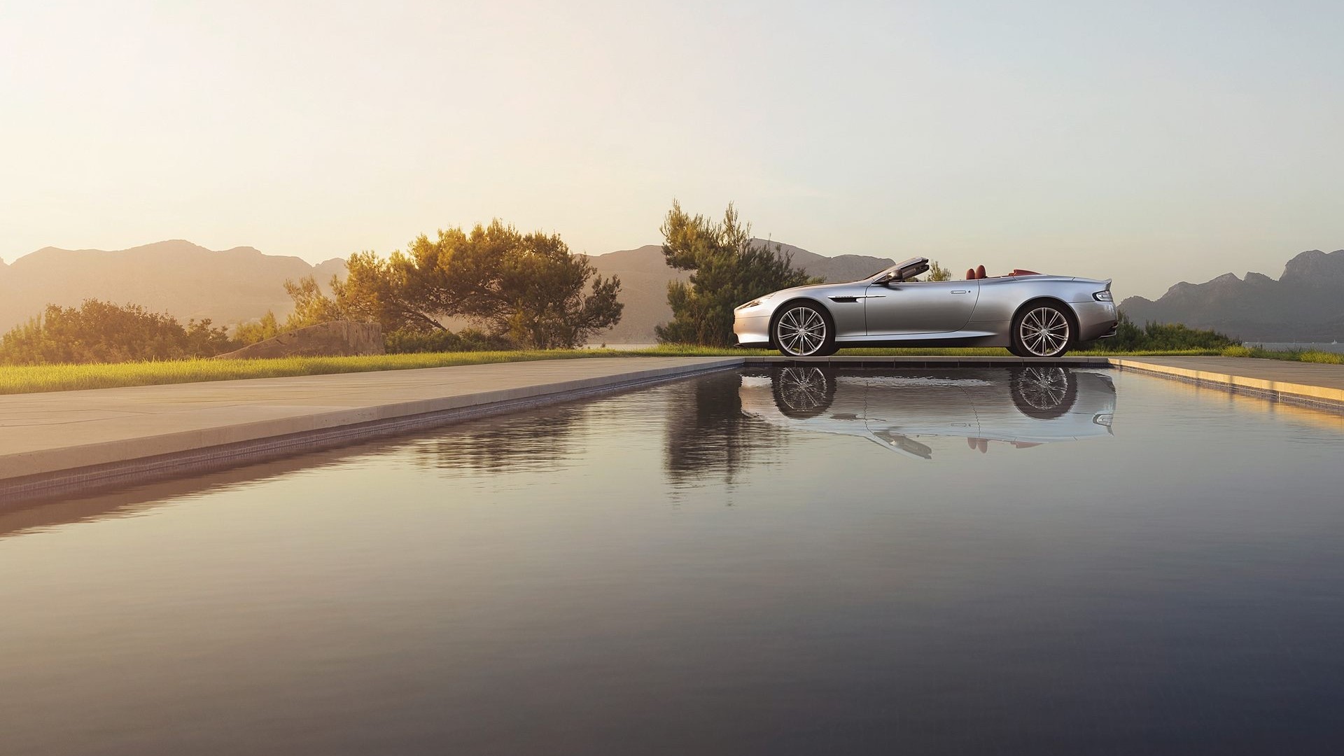 Silver Aston Martin DB9 Volante convertible by infinity pool HD Wallpaper