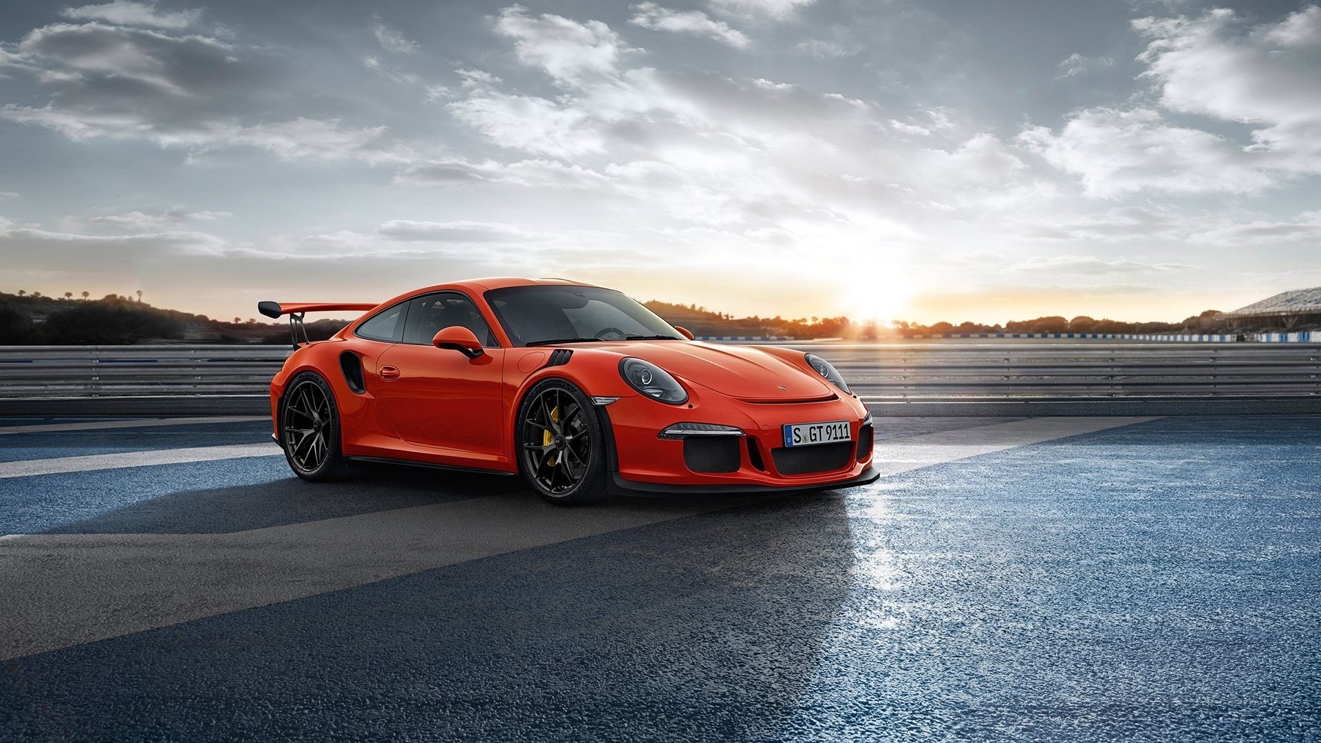 Orange Porsche 911 GT3 RS on a Racetrack HD Wallpaper