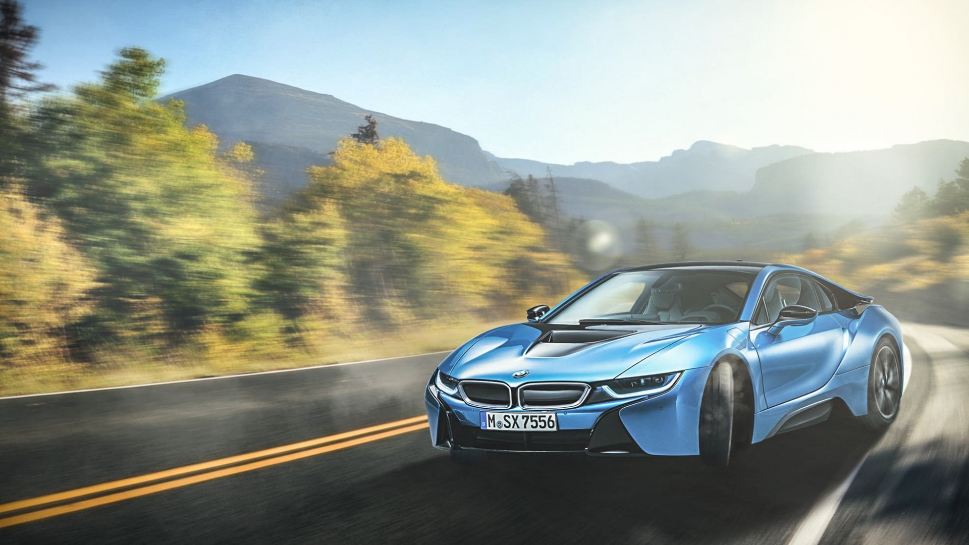 Blue BMW i8 driving on a mountain road HD Wallpaper