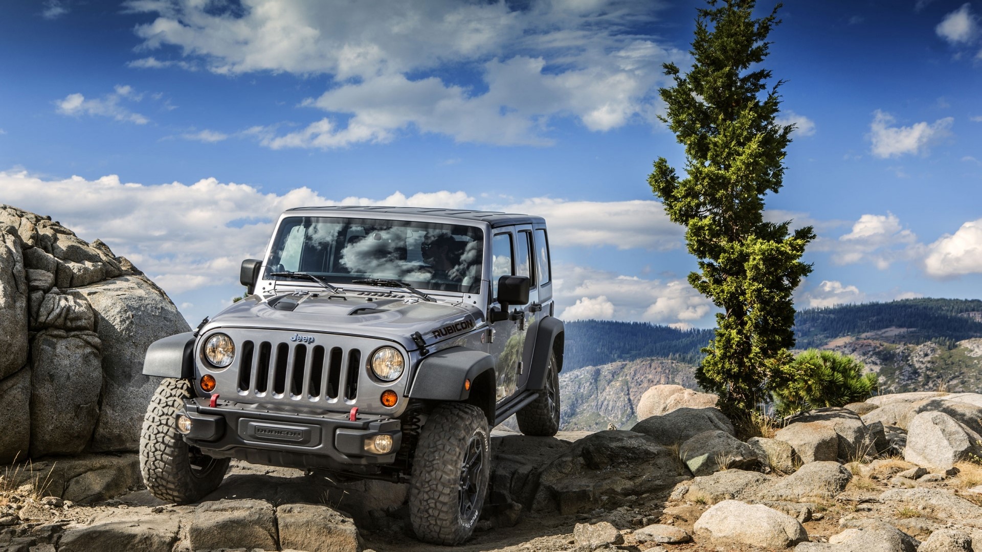 Silver Jeep Wrangler Rubicon on rocky terrain HD Wallpaper