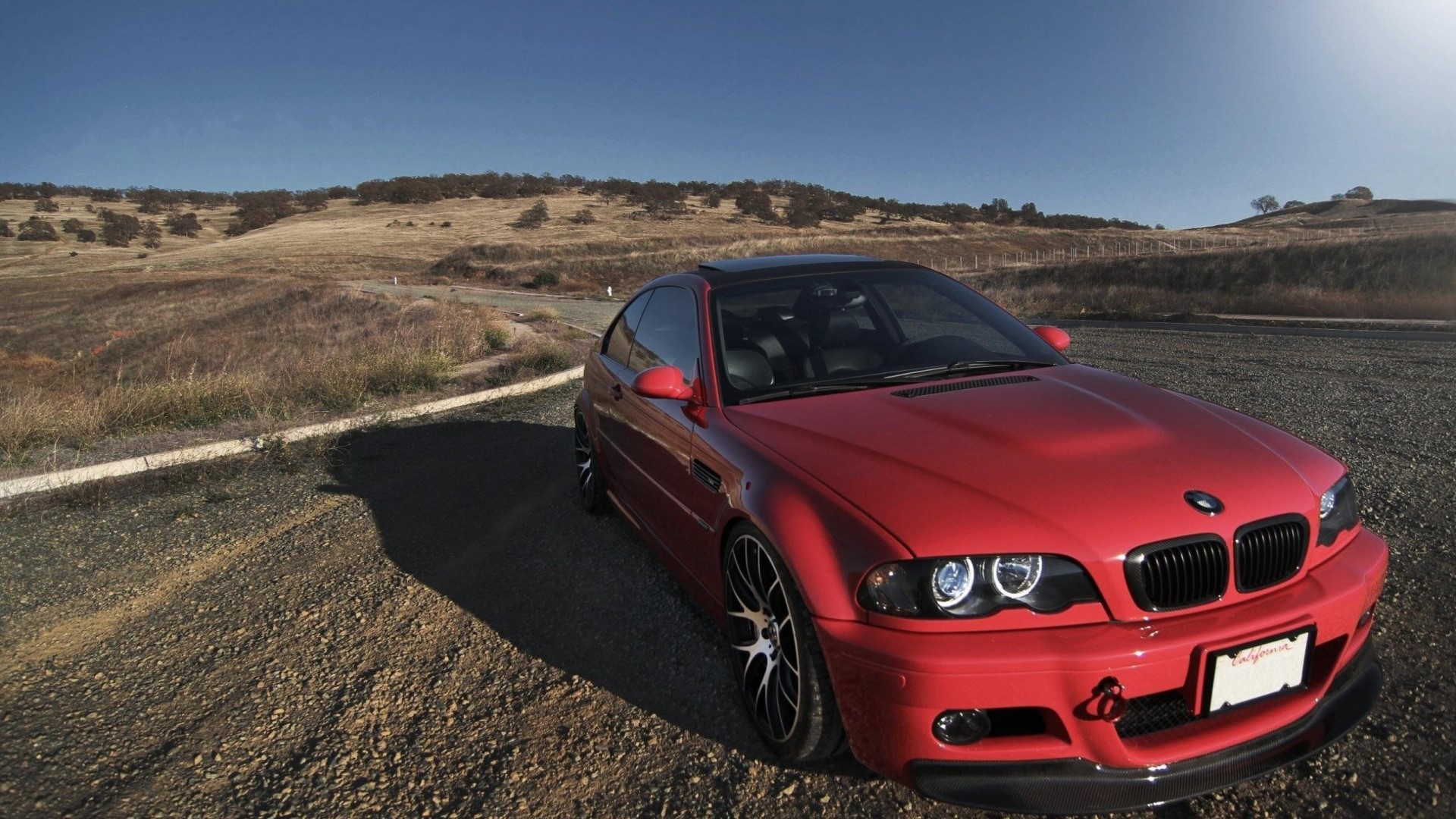 Red BMW E46 M3 parked on a dirt road HD Wallpaper