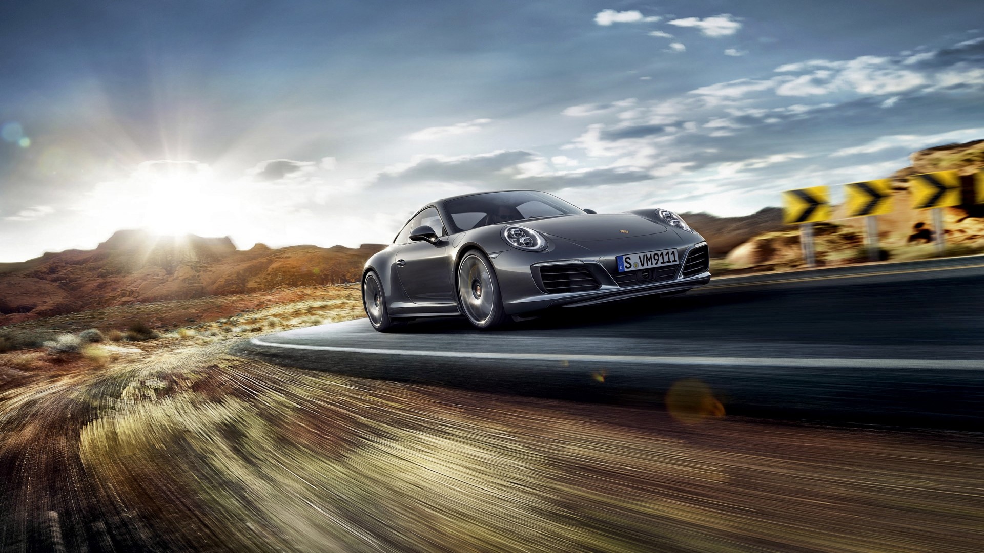 Porsche 911 Carrera 4S driving on a desert road HD Wallpaper