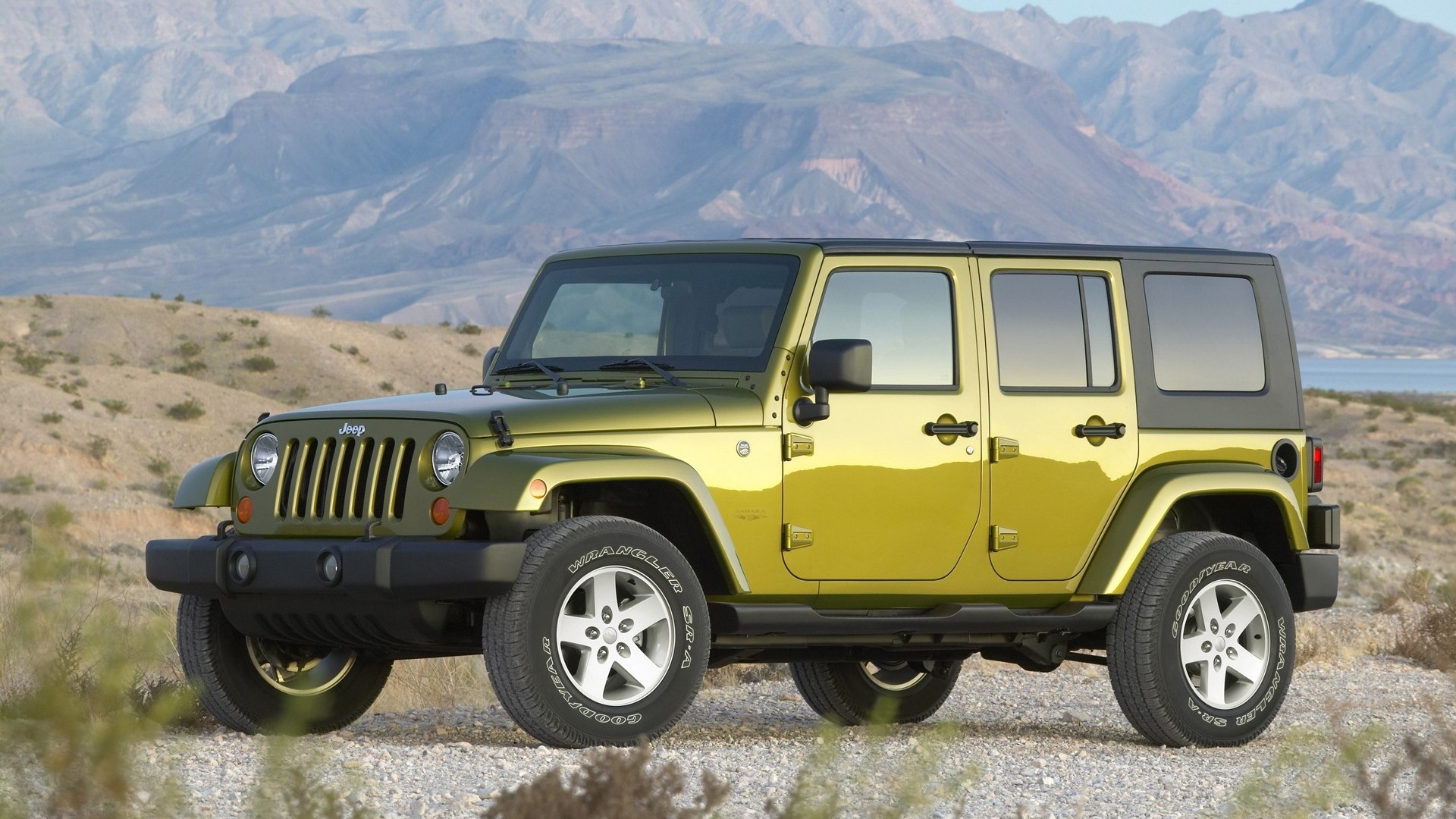 Green Jeep Wrangler Rubicon in a desert landscape HD Wallpaper