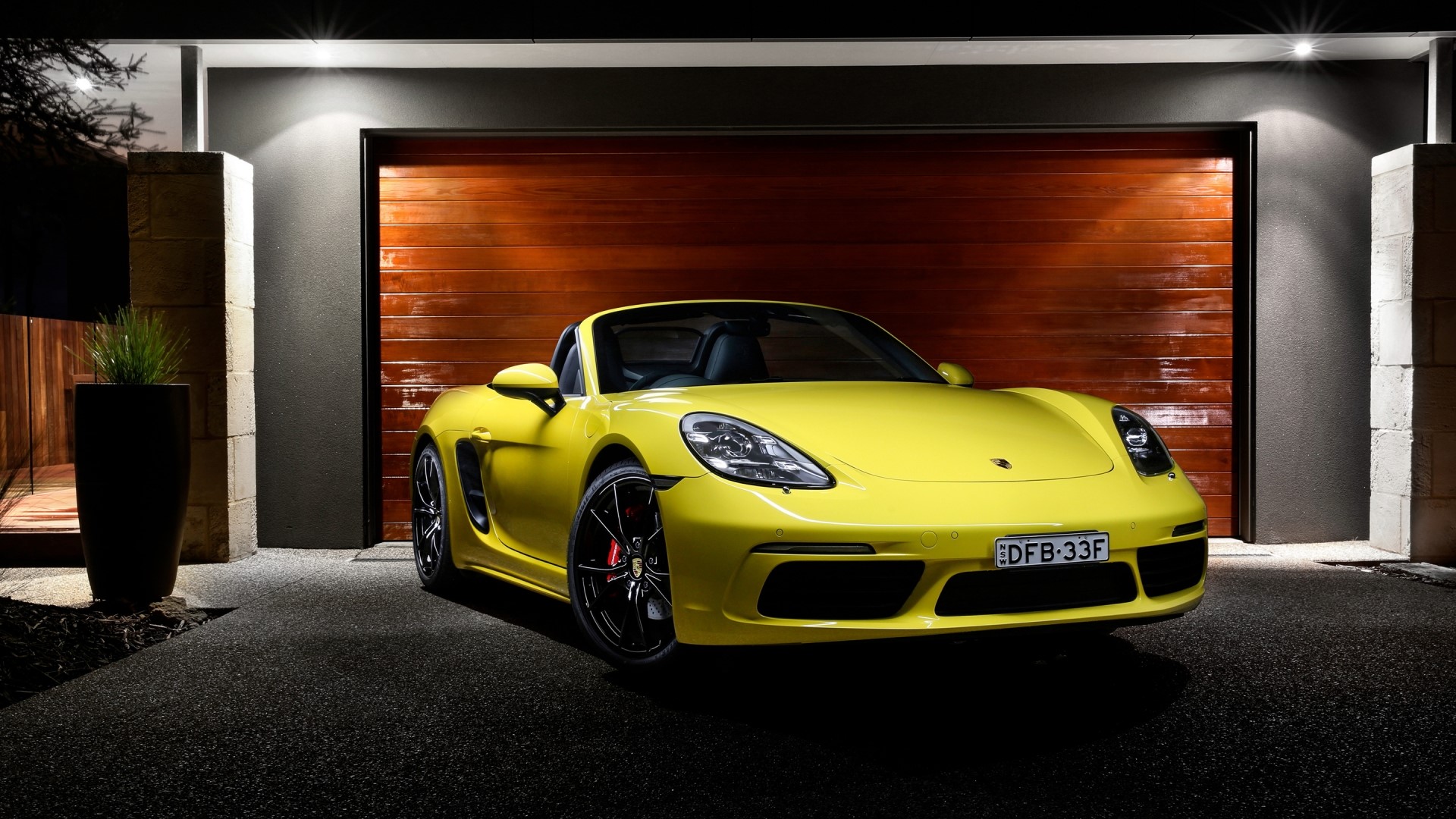 Yellow 2016 Porsche Boxster parked in front of garage HD Wallpaper