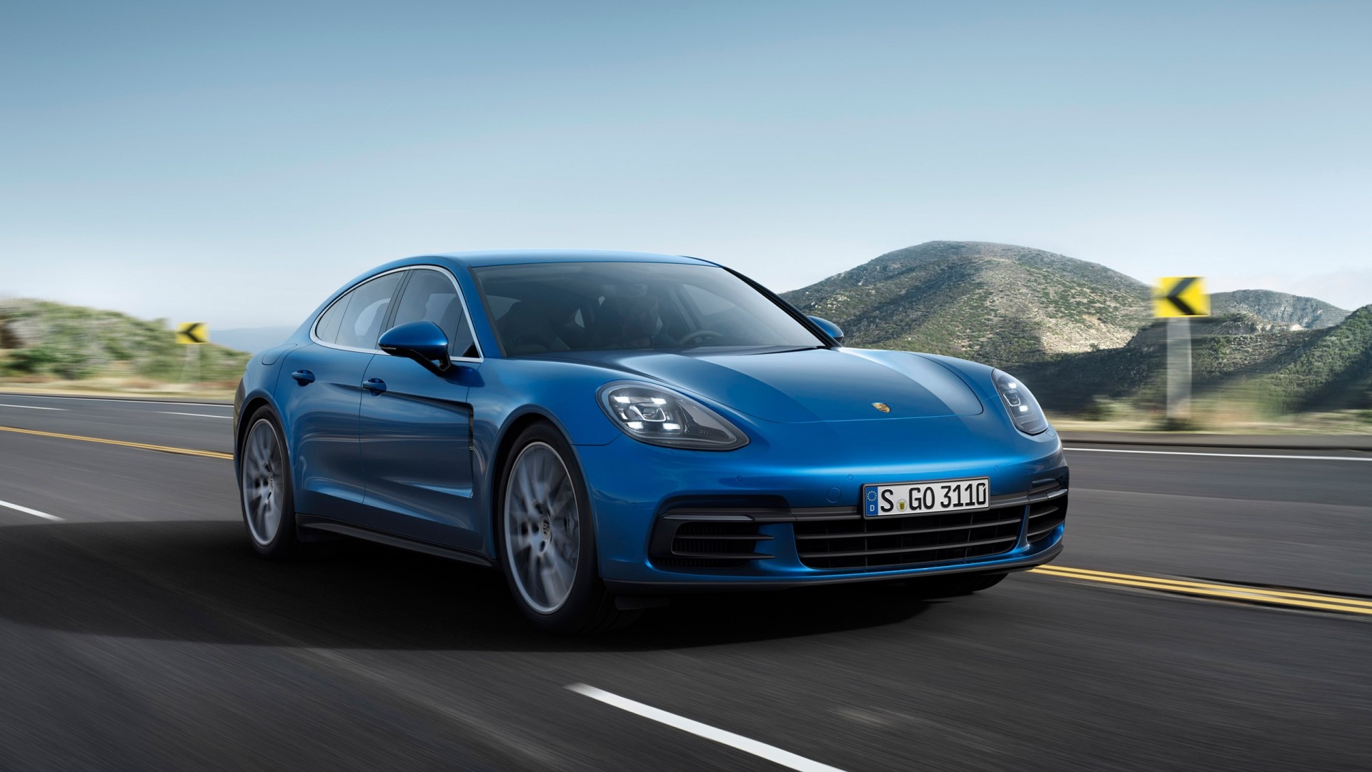 Blue Porsche Panamera driving on a road HD Wallpaper