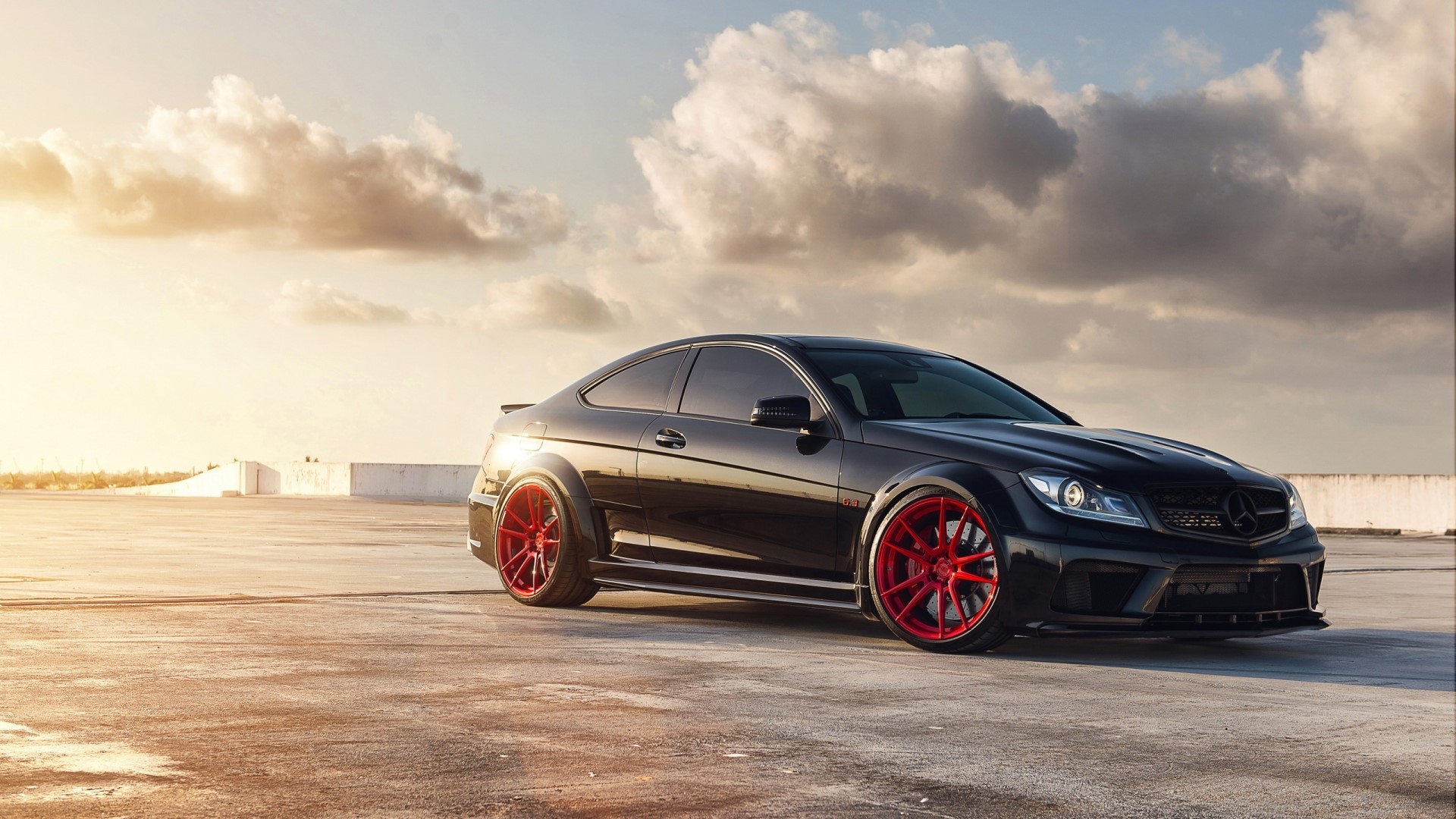 Black Mercedes Benz C63 AMG with red wheels HD Wallpaper