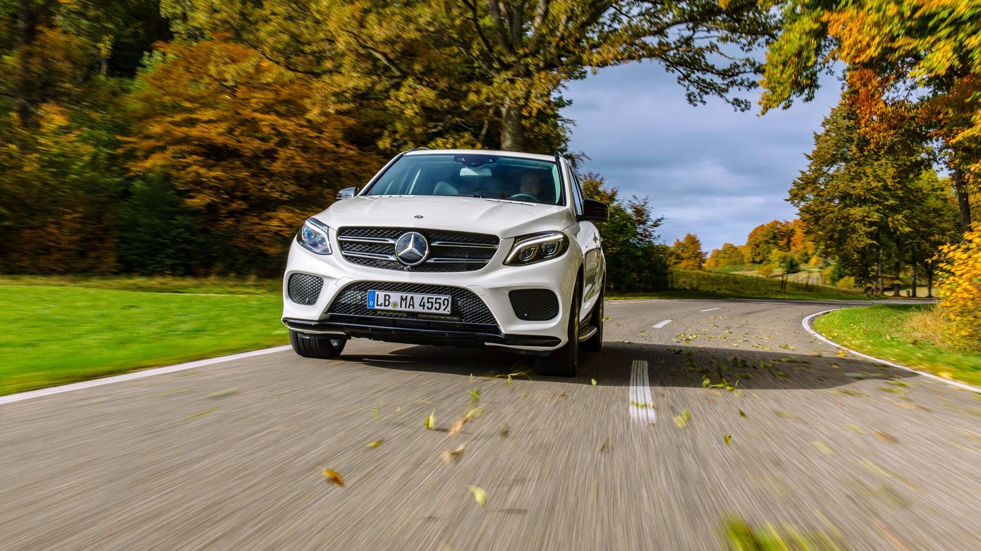 White Mercedes-Benz GLE driving on a road in autumn HD Wallpaper