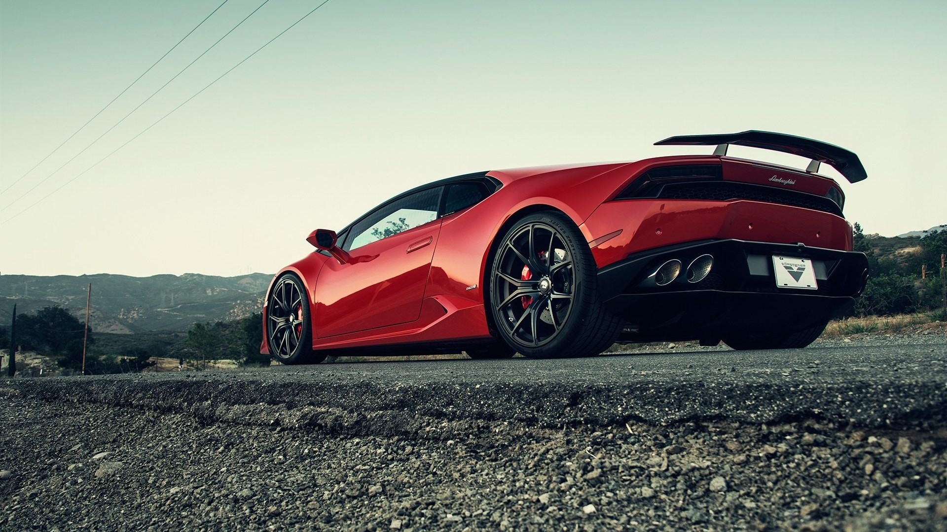 Red Lamborghini Huracan parked on a road HD Wallpaper