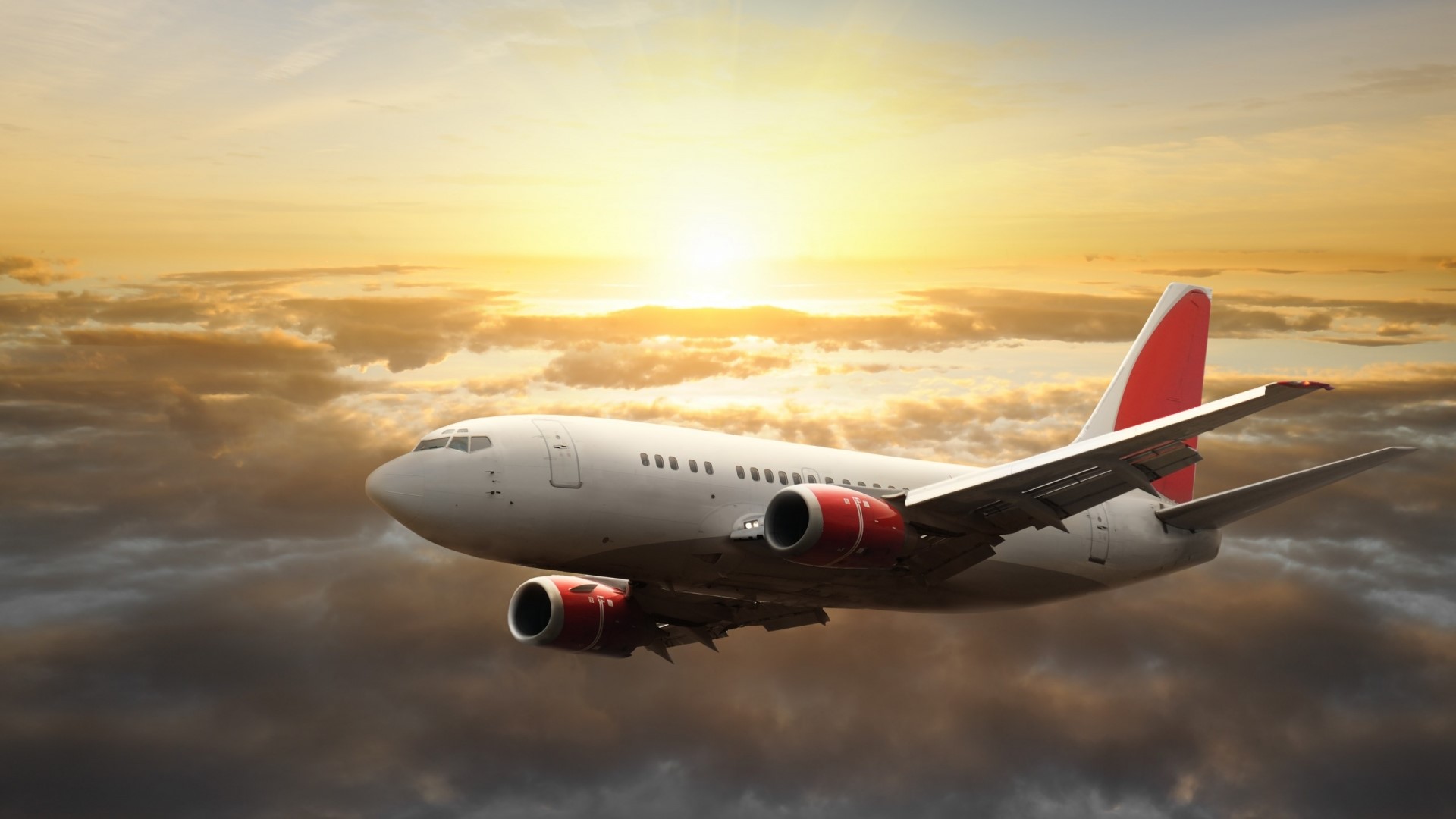 Airplane flying through clouds at sunset HD Wallpaper
