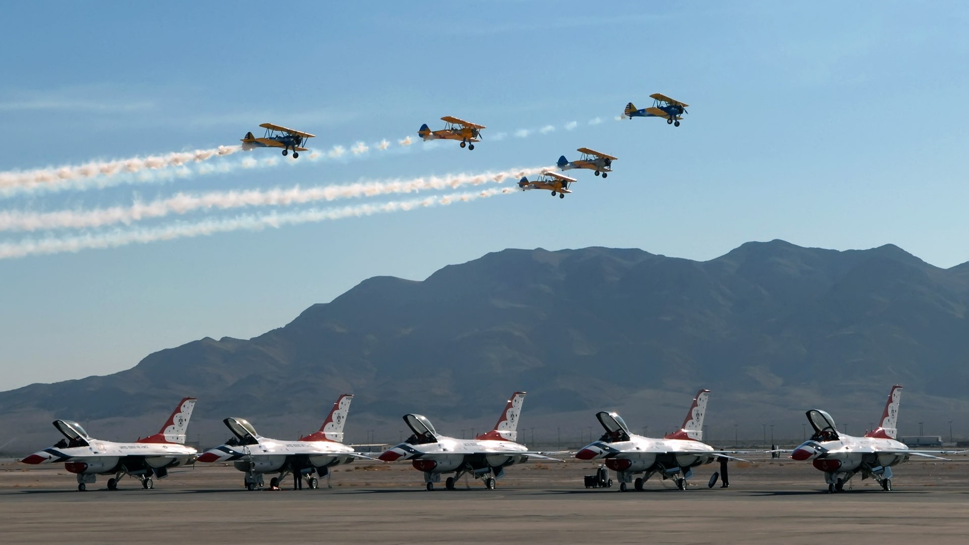 Fighter jets and biplanes perform aerial maneuvers HD Wallpaper