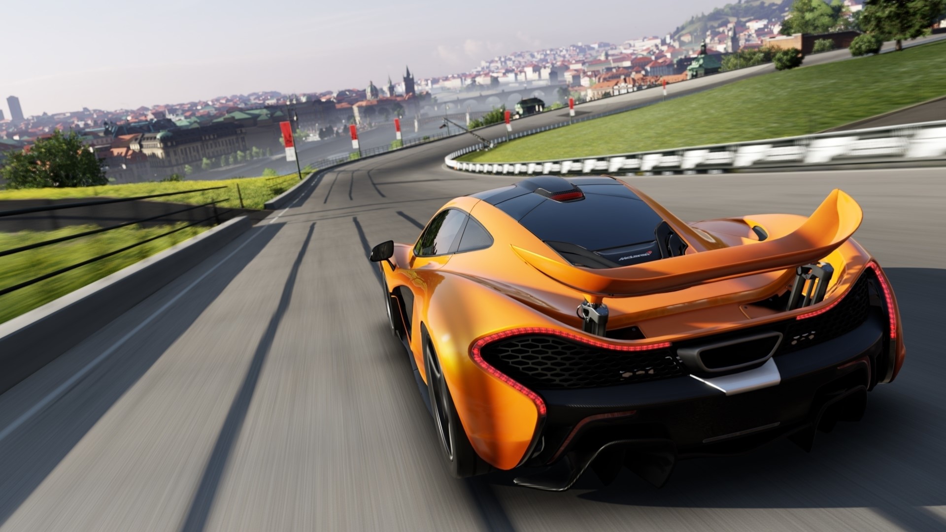 Orange McLaren P1 driving on a race track HD Wallpaper