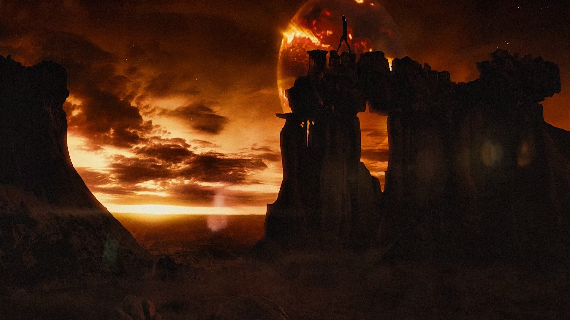 Riddick on a rocky planet with a burning planet in the sky HD Wallpaper