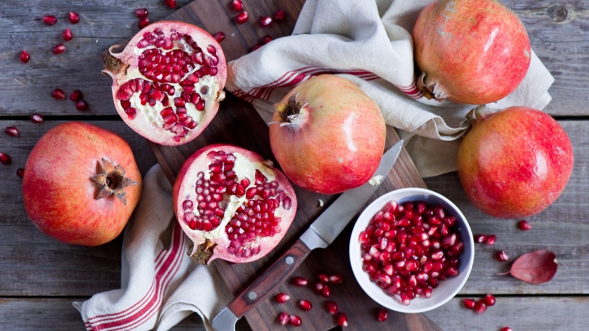 Pomegranates and Seeds on Wooden Table HD Wallpaper