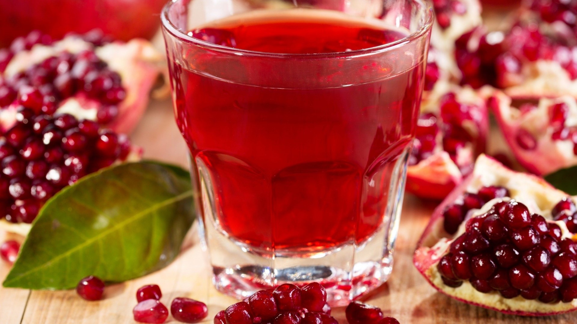 Pomegranate juice and fruit on a wooden table HD Wallpaper
