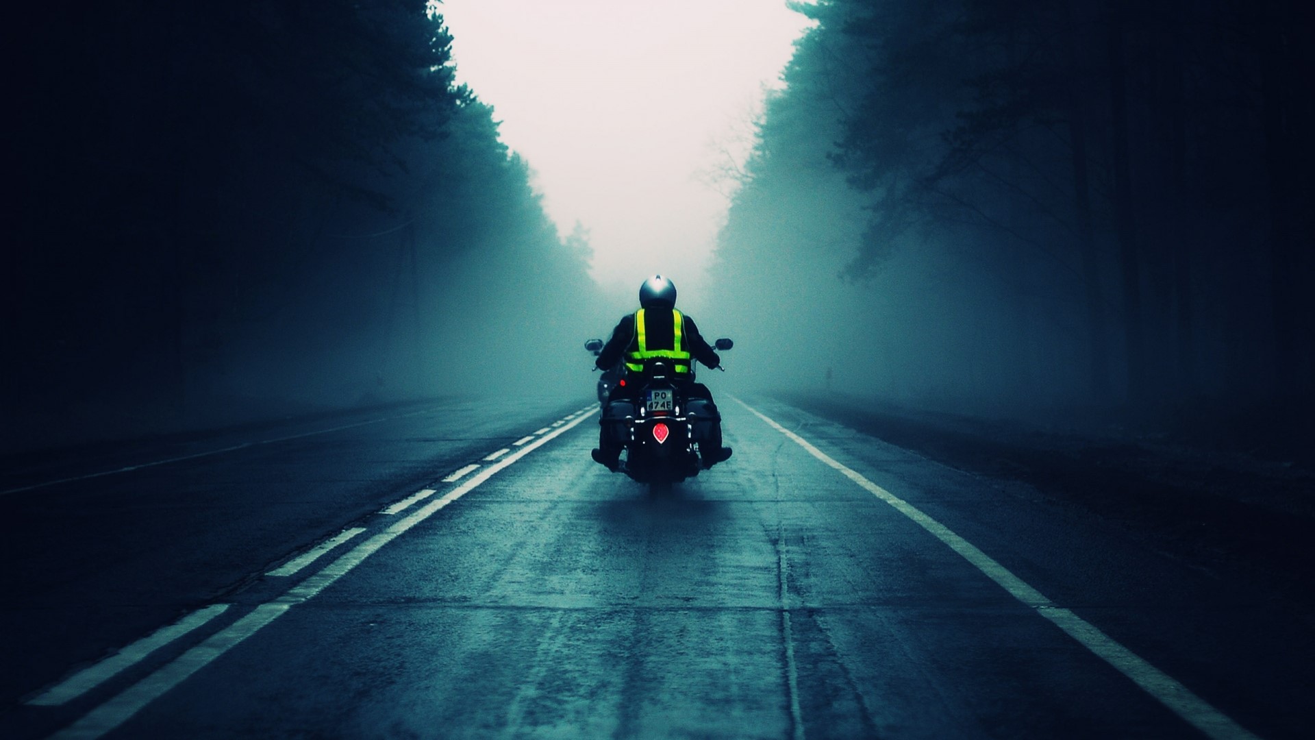 Motorcyclist on a foggy road HD Wallpaper
