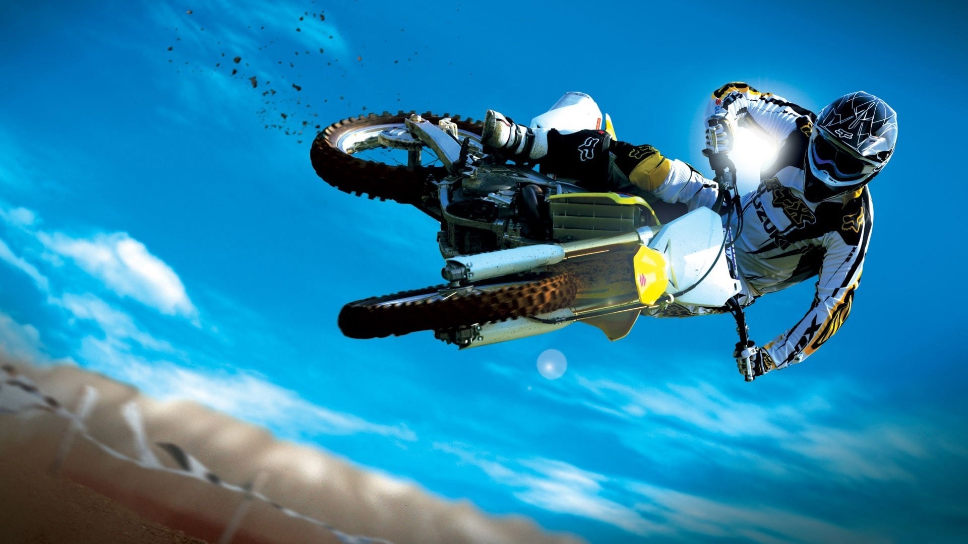 Motocross rider performing a jump on a Suzuki RM-Z450 HD Wallpaper