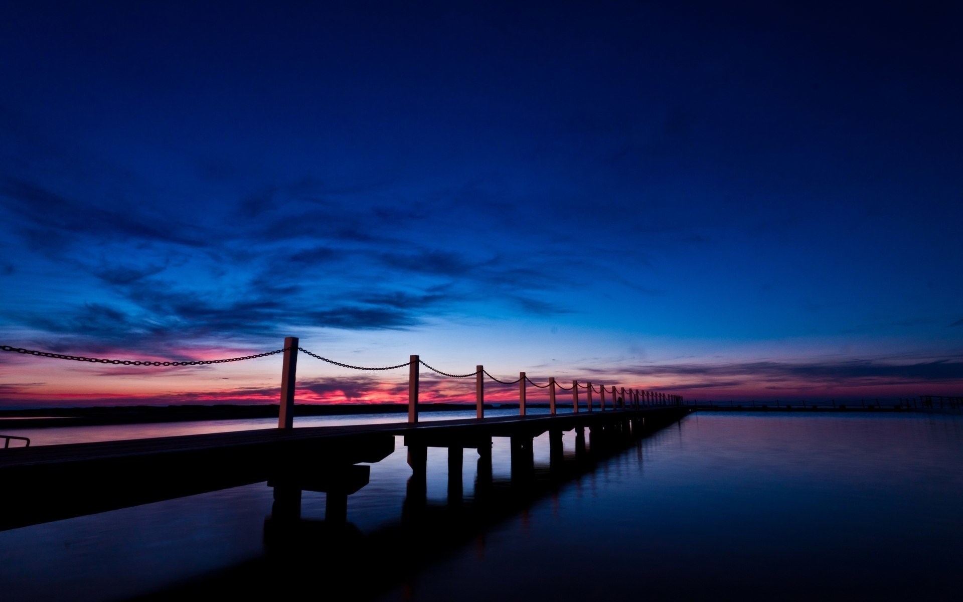 Pier over water at dusk with colorful sky HD Wallpaper