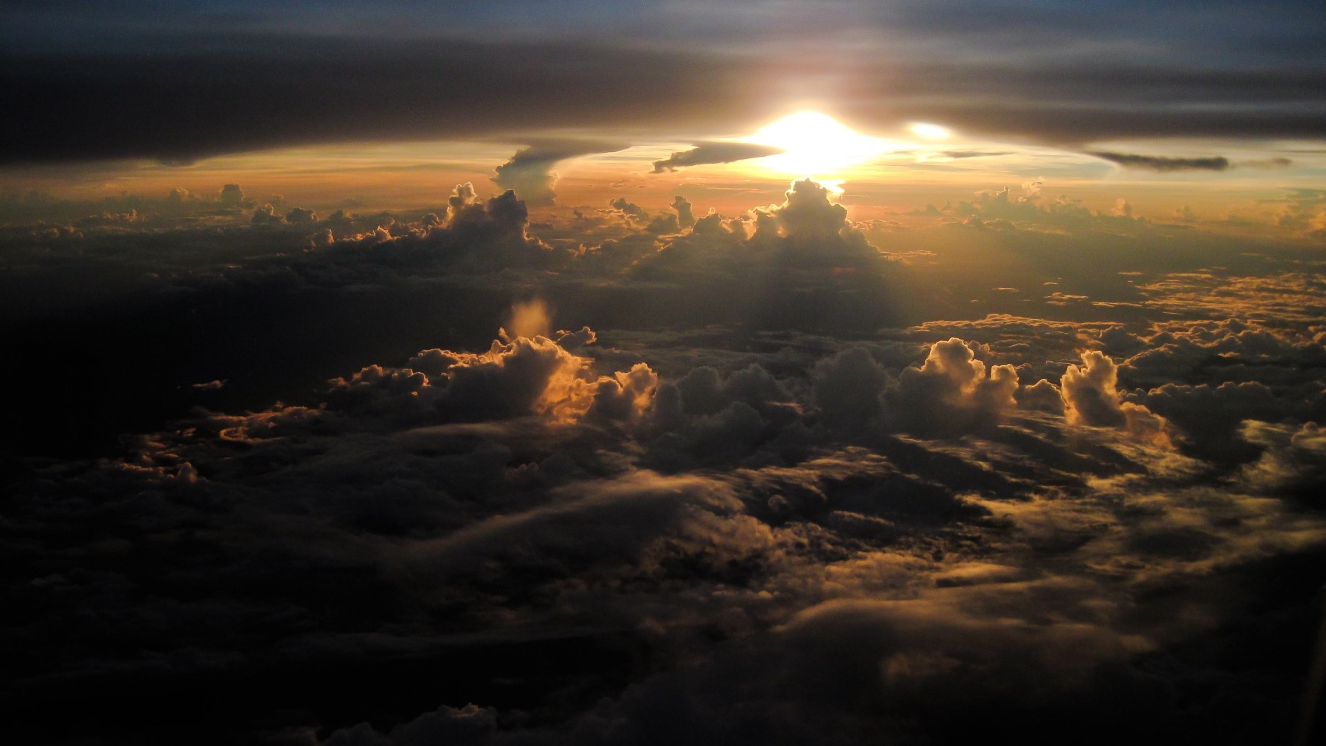 Sunset over clouds viewed from a plane HD Wallpaper