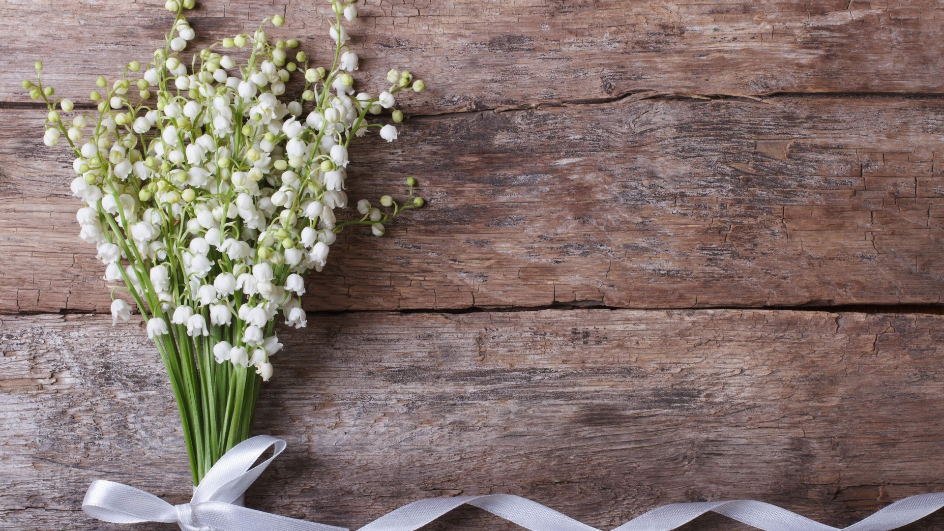 Lily of the valley bouquet on wooden background HD Wallpaper