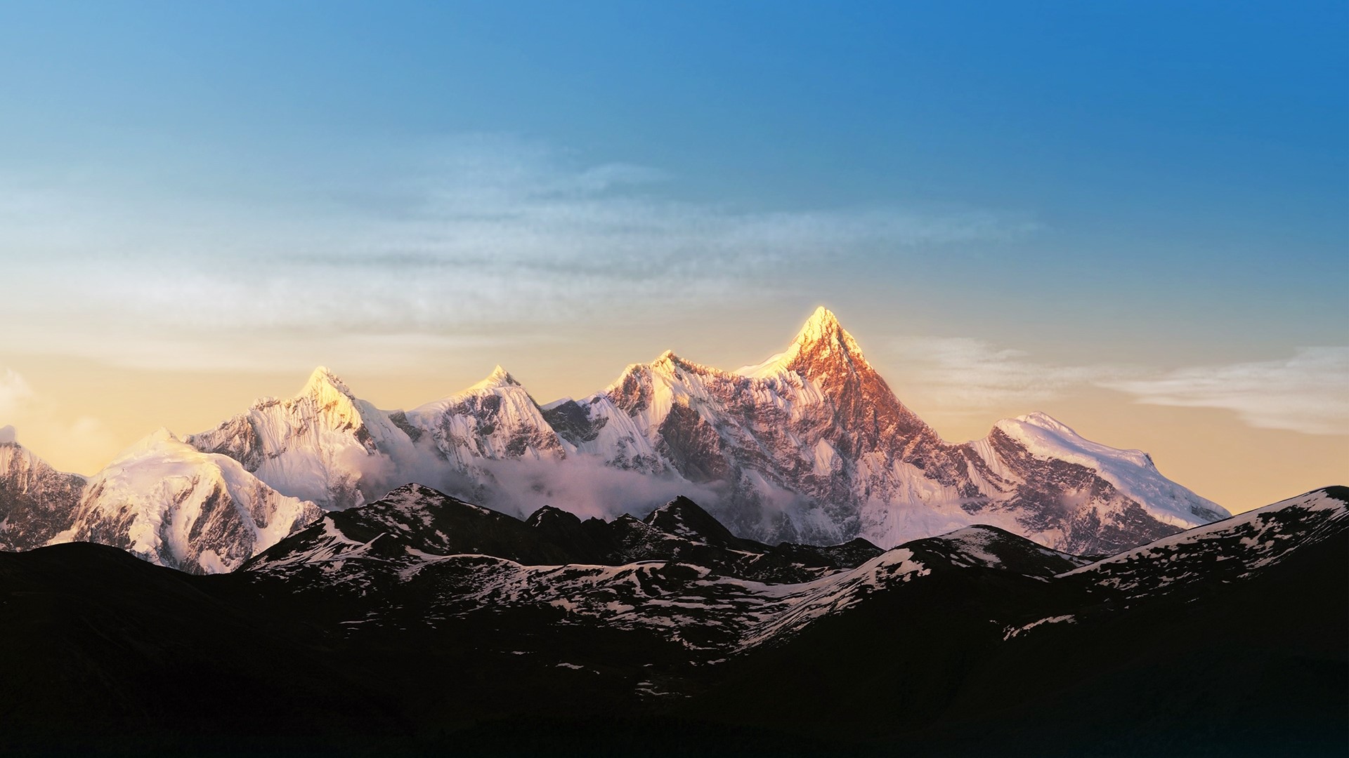 Snow-capped mountains at sunrise HD Wallpaper