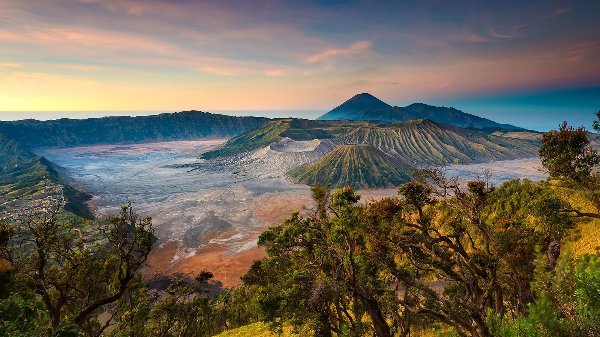 Volcanic landscape with mountains and trees at sunrise HD Wallpaper
