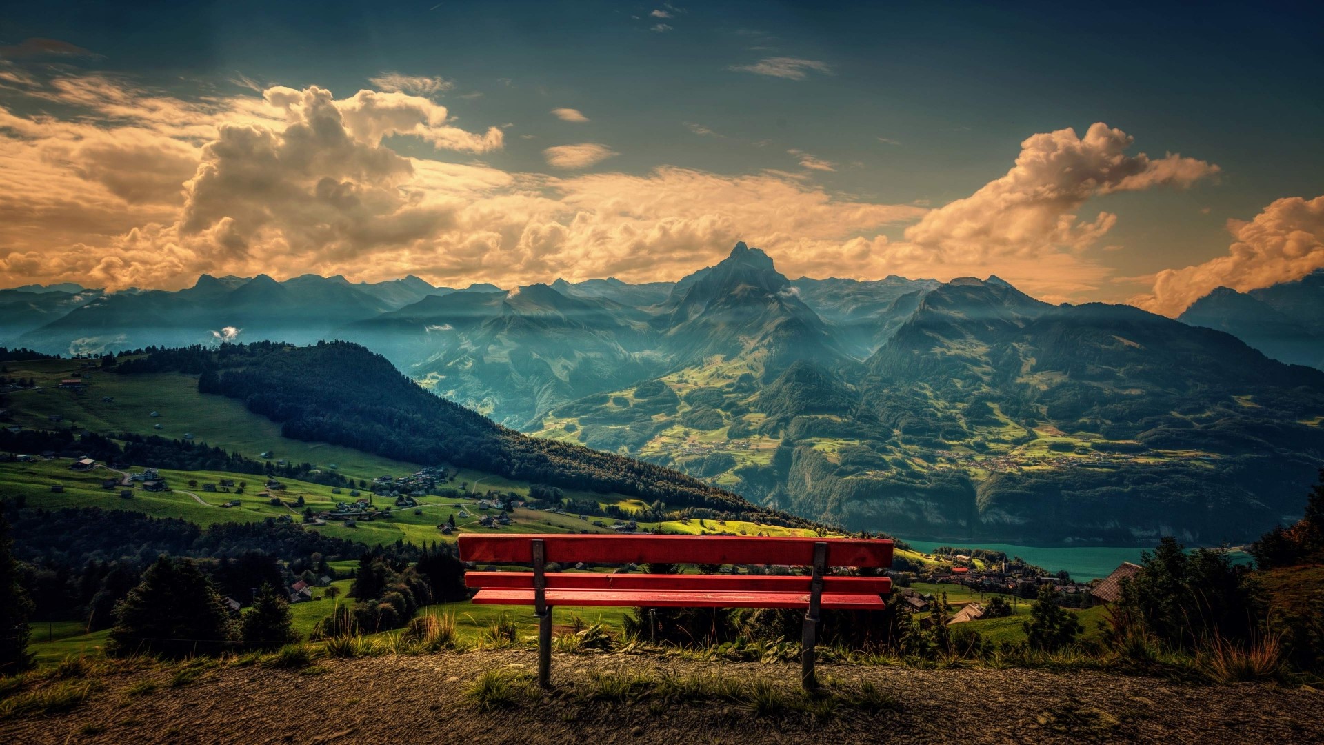 Red bench overlooking mountains and lake HD Wallpaper