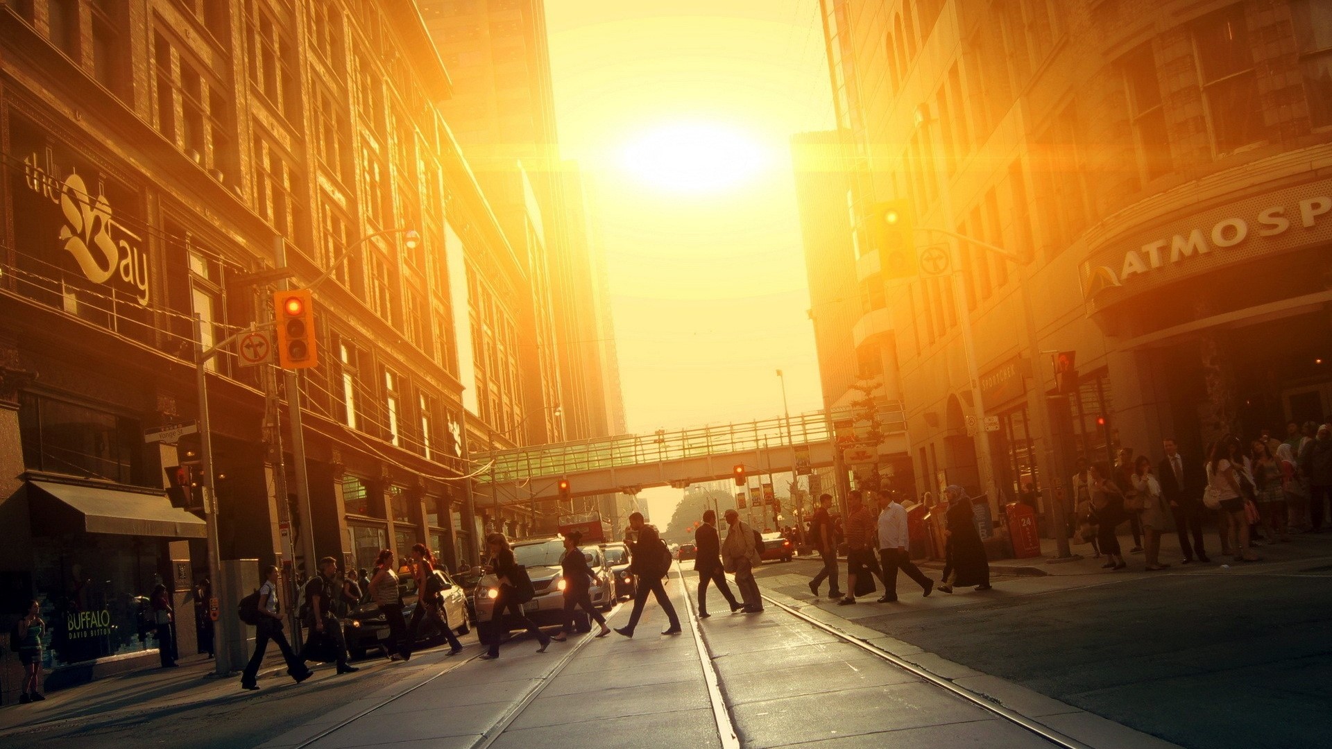 Urban street with pedestrians and cars at sunset HD Wallpaper