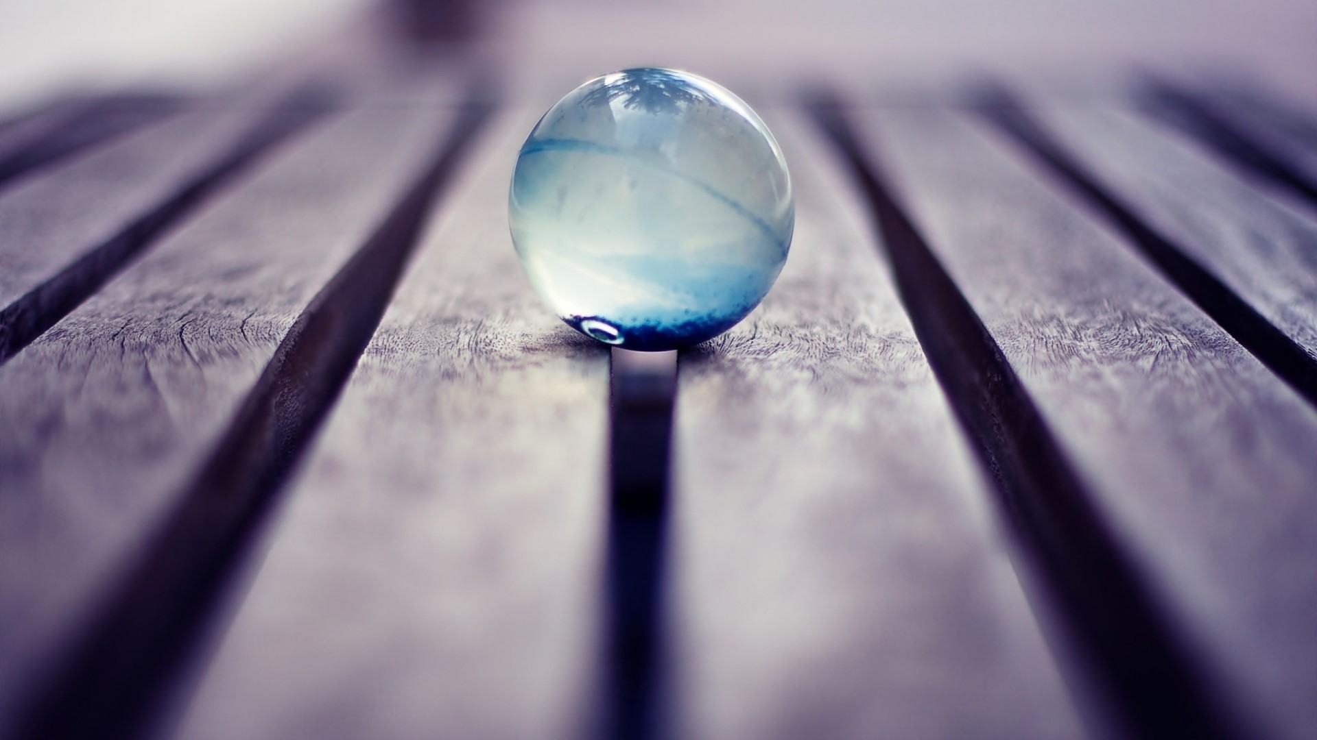 Marble on a wooden surface HD Wallpaper