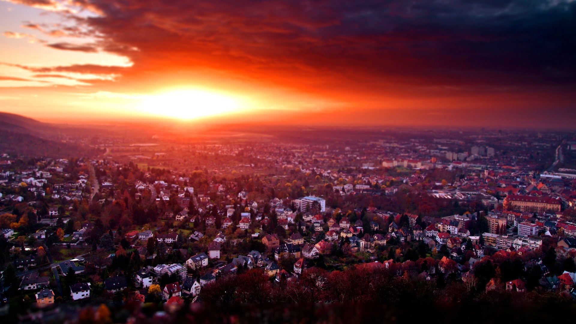 Sunset over a city with tilt-shift effect HD Wallpaper