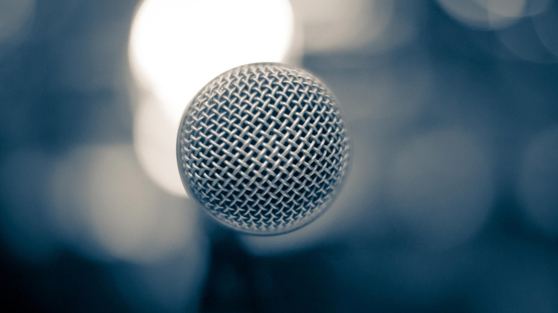 Close-up of a metal microphone with bokeh background HD Wallpaper