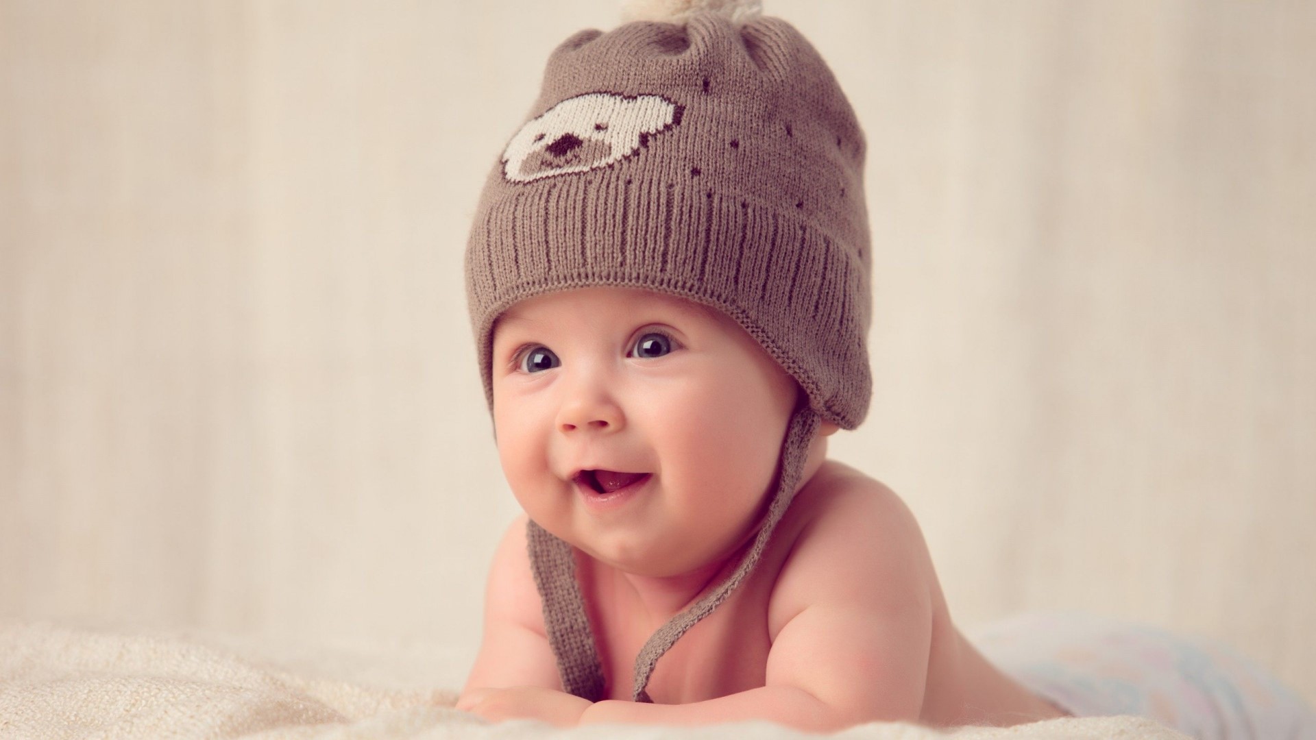 Happy Baby Wearing a Bear Hat HD Wallpaper