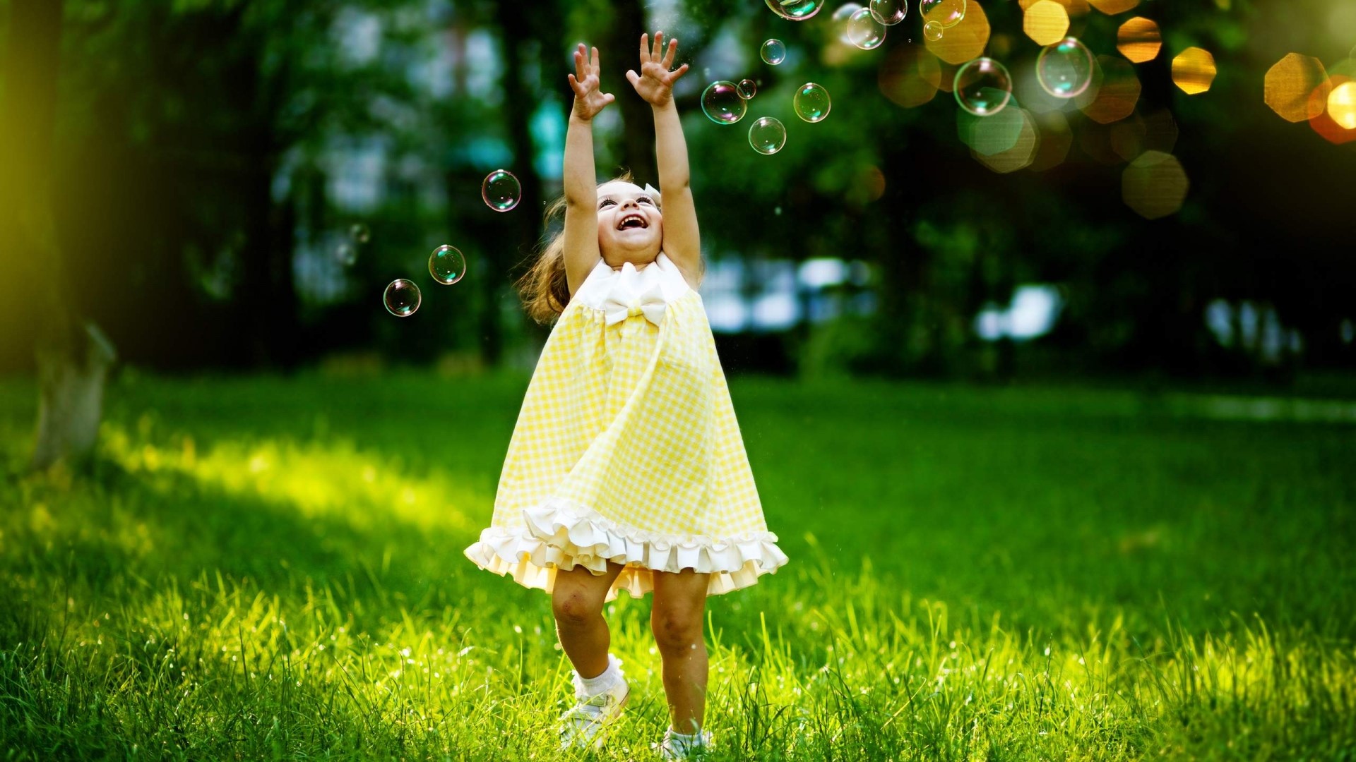 Happy Girl Playing with Bubbles in a Park HD Wallpaper