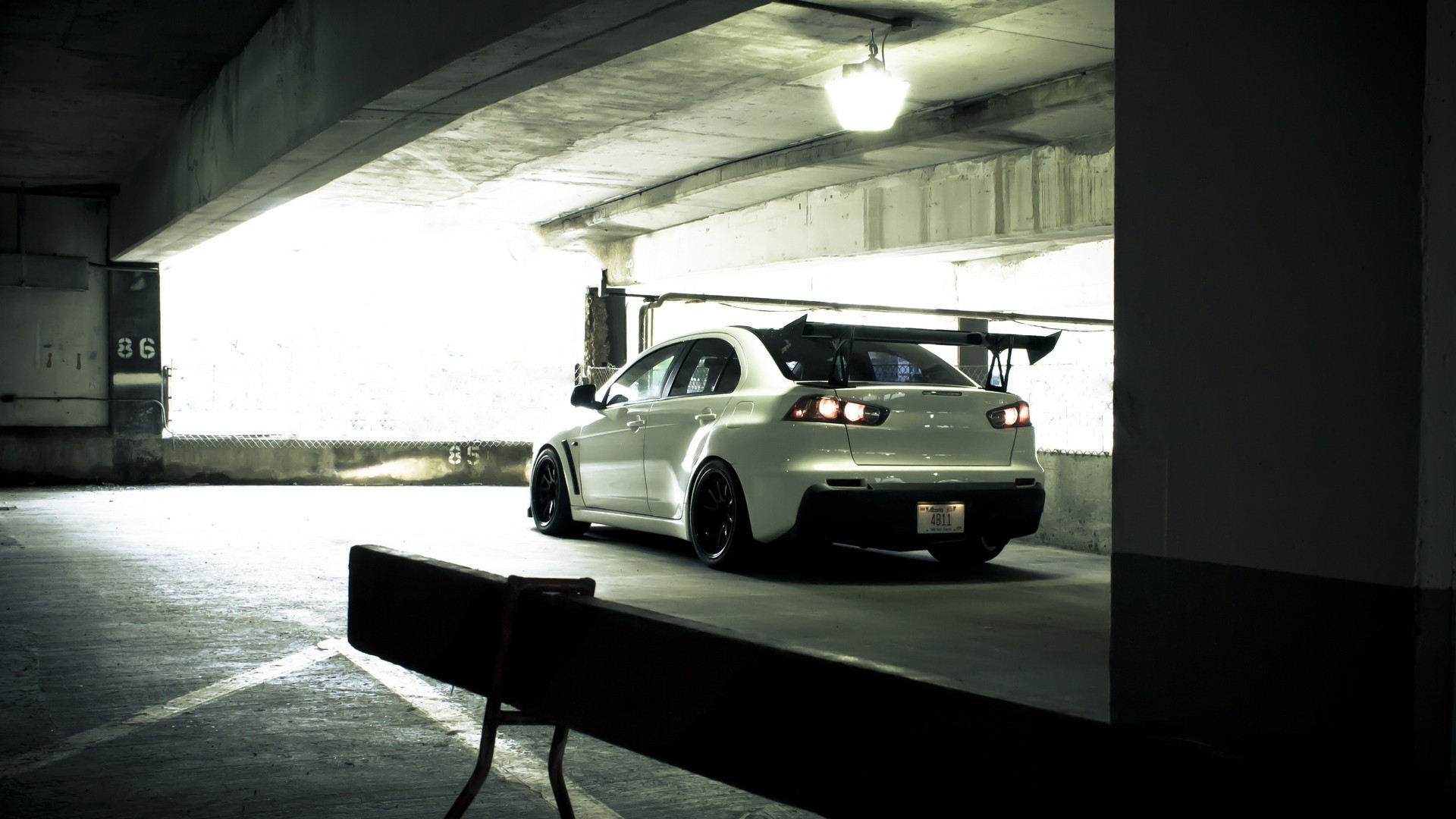 White Mitsubishi Lancer Evolution Sports Sedan in Parking Garage HD Wallpaper