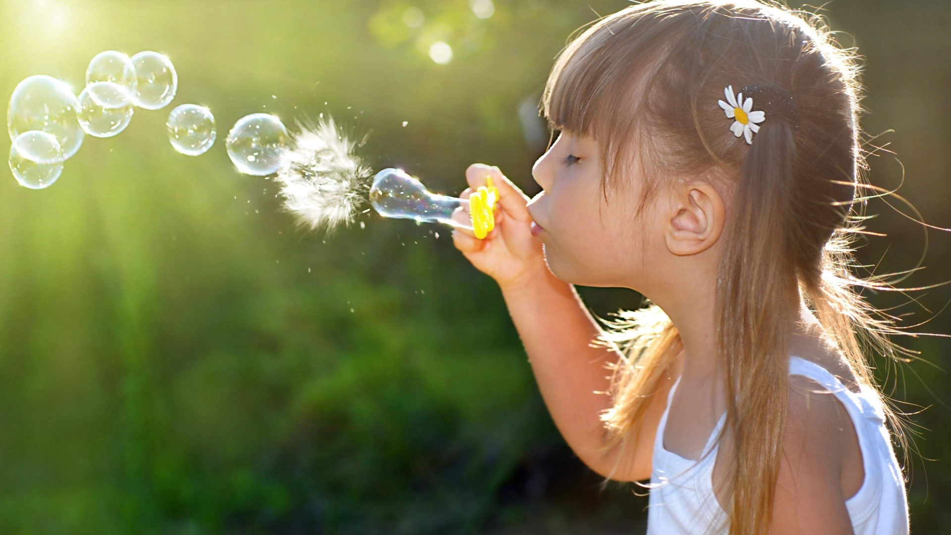 Girl blowing bubbles in sunlight HD Wallpaper