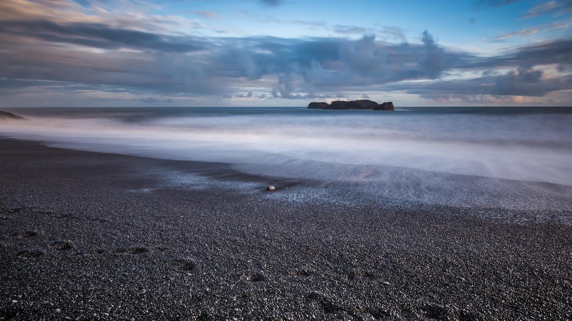 Black pebble beach with sea stacks and clouds HD Wallpaper