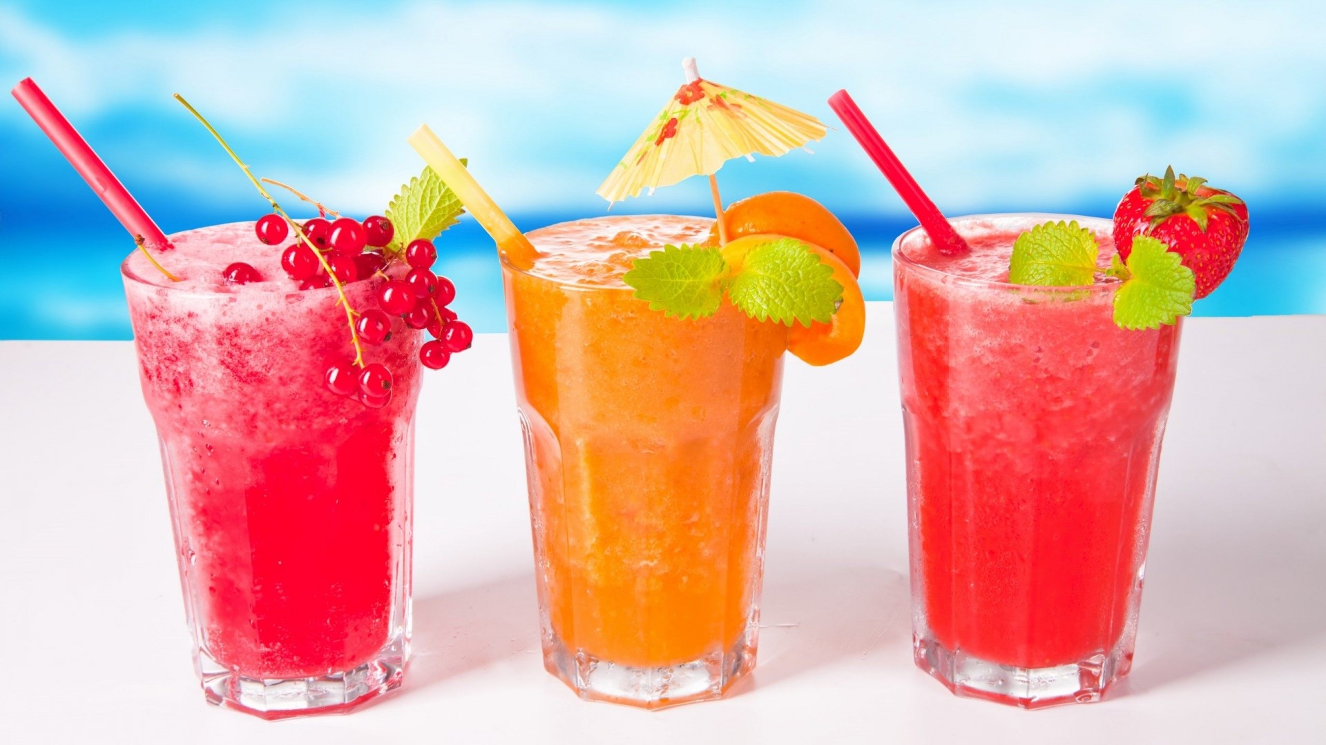 Three Fruity Drinks with Garnishes HD Wallpaper
