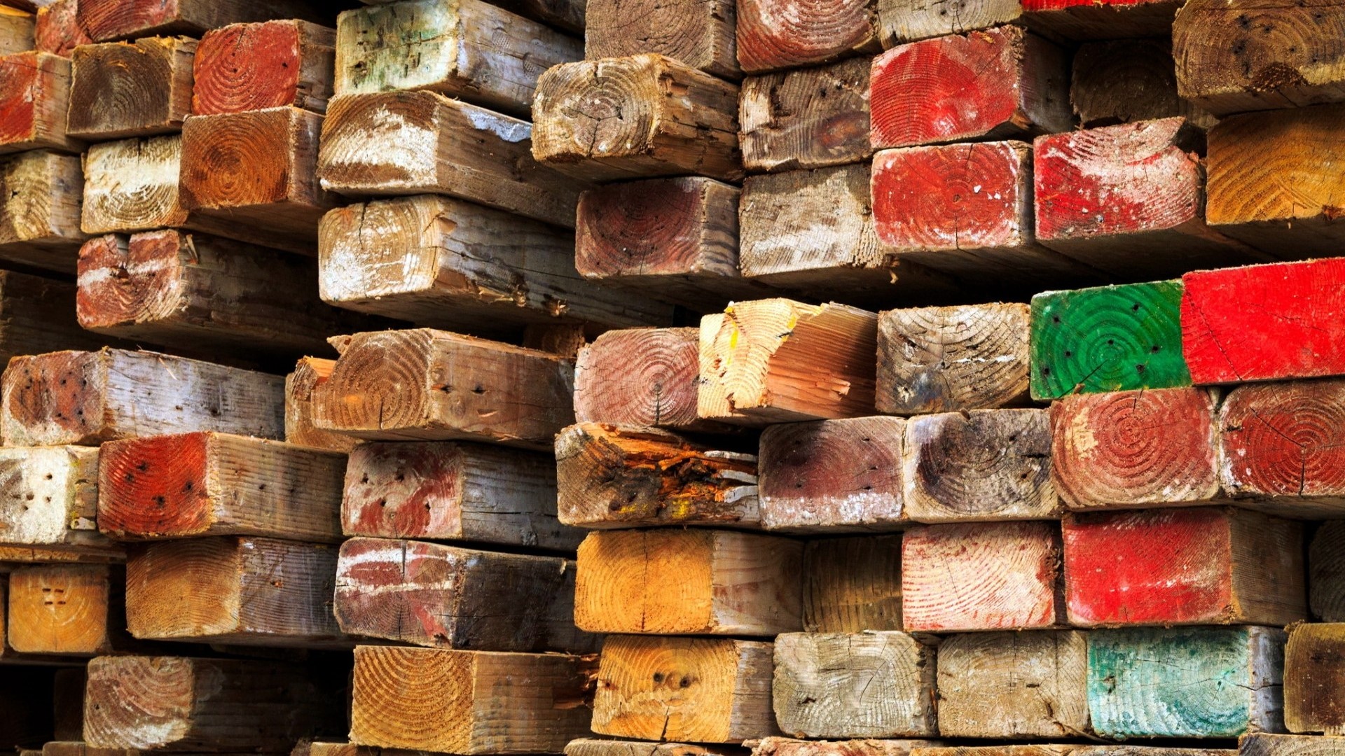 Stacked colored and weathered wooden beams HD Wallpaper