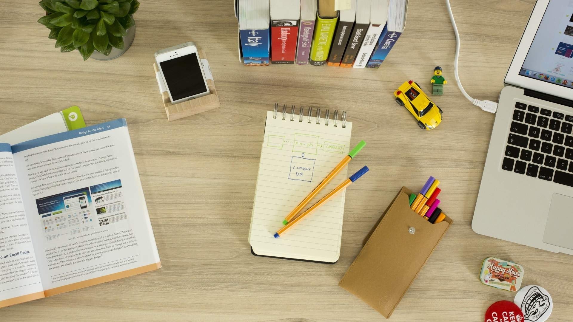 Desk with laptop, books, phone, and stationery HD Wallpaper